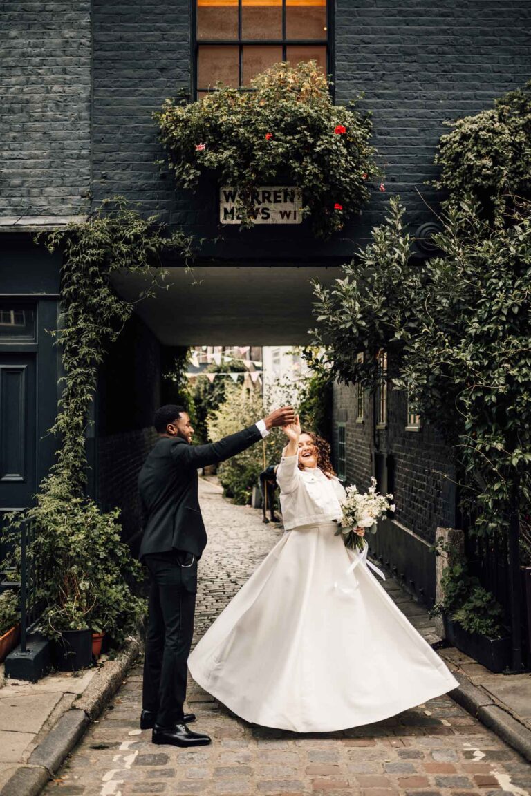 A bride and groom dance for their wedding portraits, creating a beautiful frame within a frame