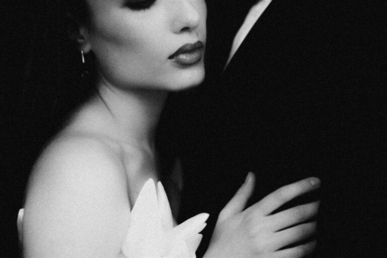 A bride leans into her groom's chest in this stylised fine art image by Muse & Mirror taken at our Thrive conference in London.