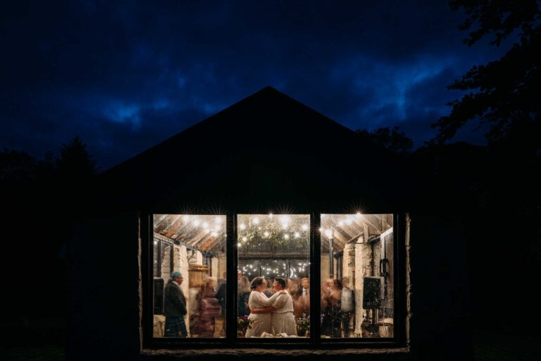 Brides embrace for this creative Nighttime Wedding Photo