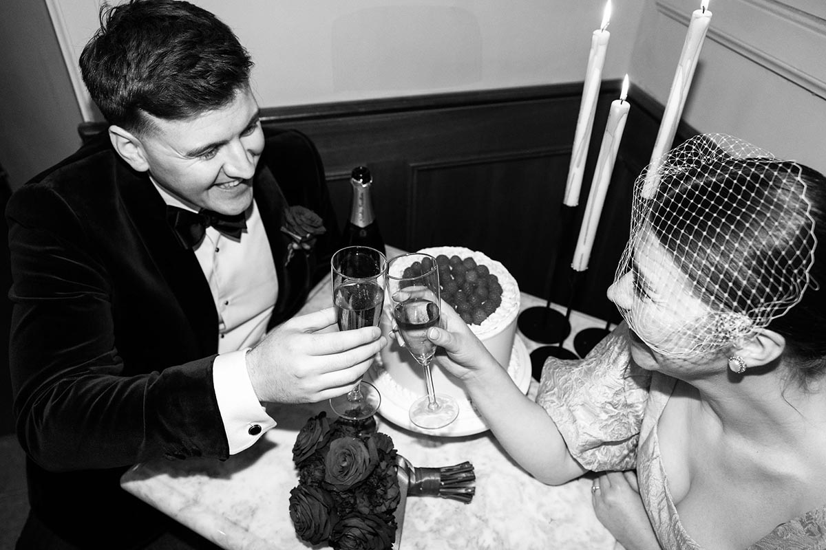 Joyful 'Just Married' Celebration with Champagne The newlyweds share a joyous toast with champagne, capturing the essence of their intimate elopement celebration.