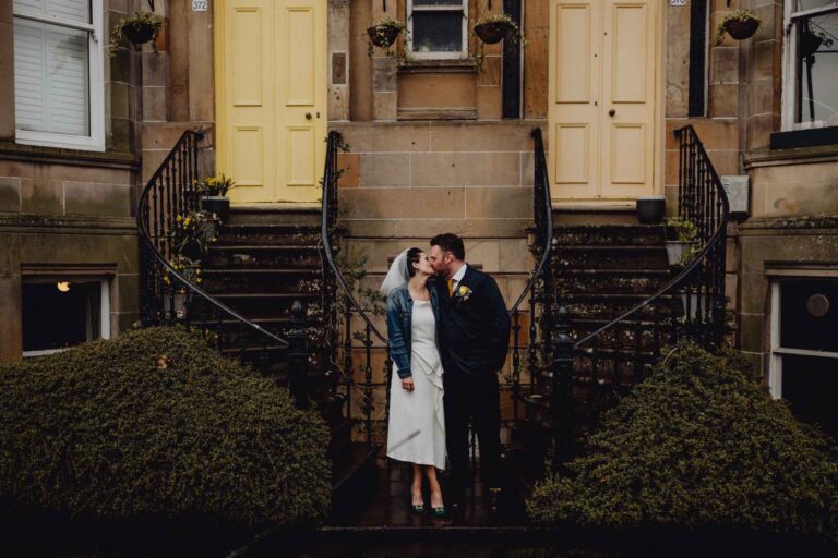 A bride and groom pose for a Wes Anderson Inspired Wedding Photograph.