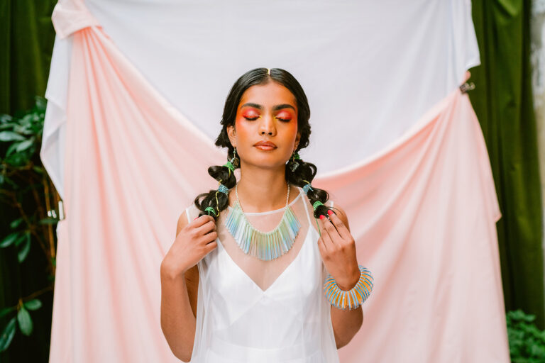 A stunning model with bold makeup closes here eyes thoughtfully, a great photo to feature in a blog about burnout for wedding photographers.