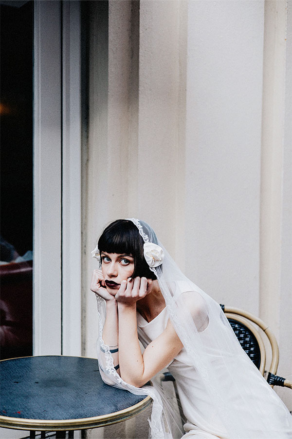 A bride in a white dress and veil gazes upward toward the sky, conveying the theme wedding photography bookings slow after rebrand.