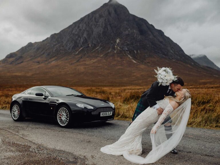 A bride and groom embrace against a dramatic backdrop. When Neil met William Wade!