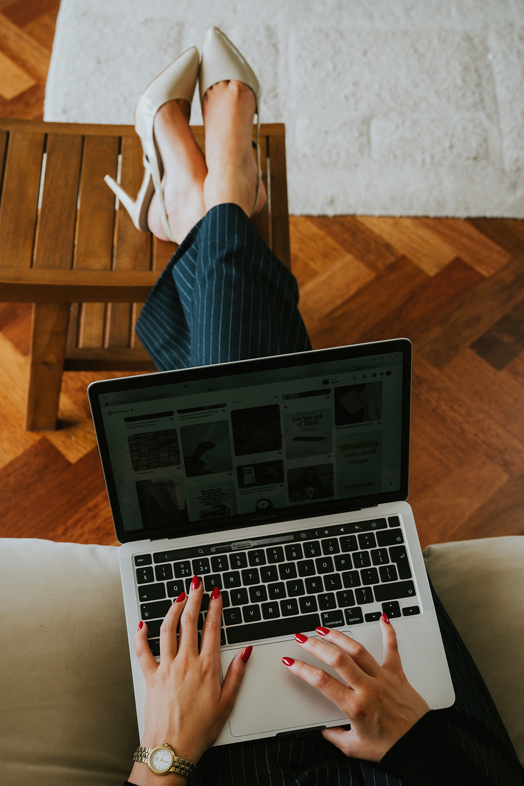 A woman in a white bathrobe sitting in a wicker chair, looking down at her phone, focused. A modern and professional tone for "ChatGPT prompts for photographers."