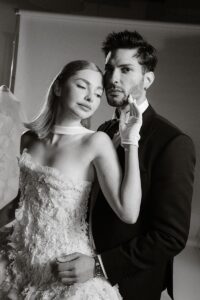 Two models dressed in wedding attire on set in a film studio by Jennifer Moher