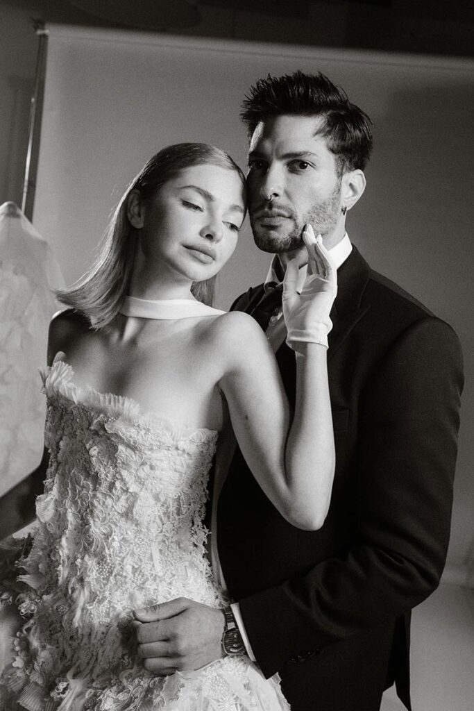 Two models dressed in wedding attire on set in a film studio by Jennifer Moher